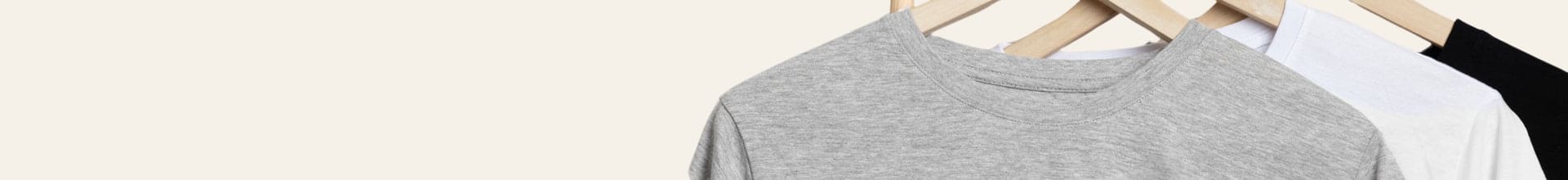 Gray t-shirt on a wooden hanger with a white background