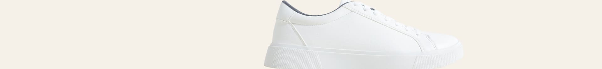 White sneaker on a beige background
