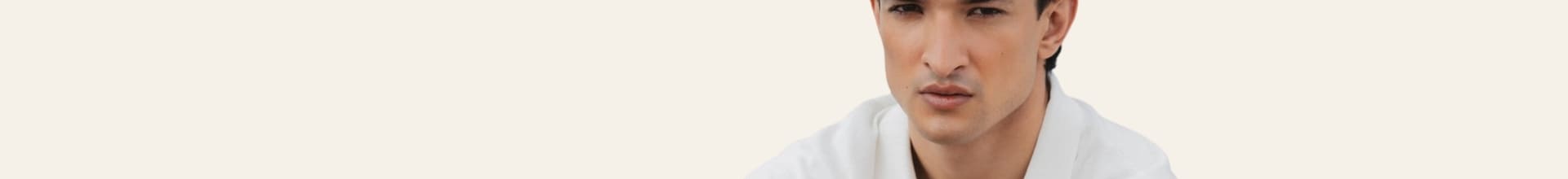 Man wearing a white shirt on a light gray background