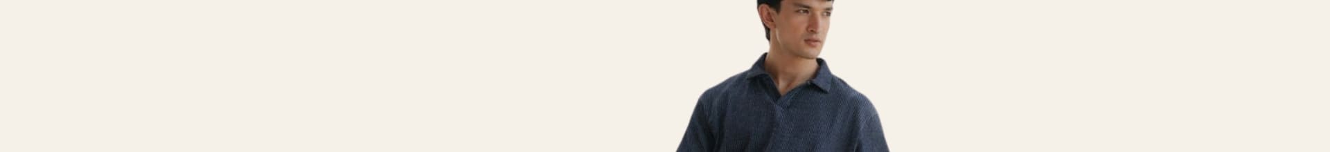 Man wearing a blue shirt against a plain background