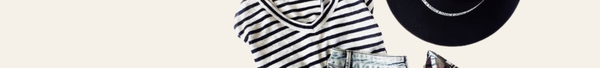 Striped shirt, black hat, and sunglasses on a light beige background