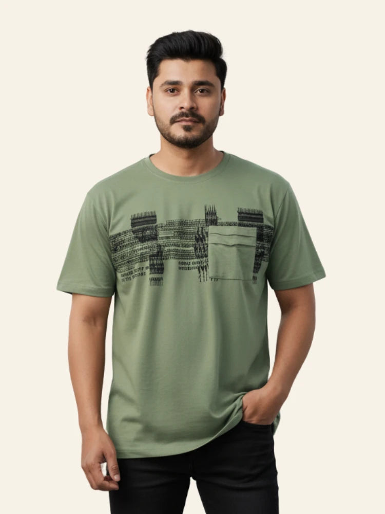 Man wearing a green t-shirt with black graphic design on a beige background