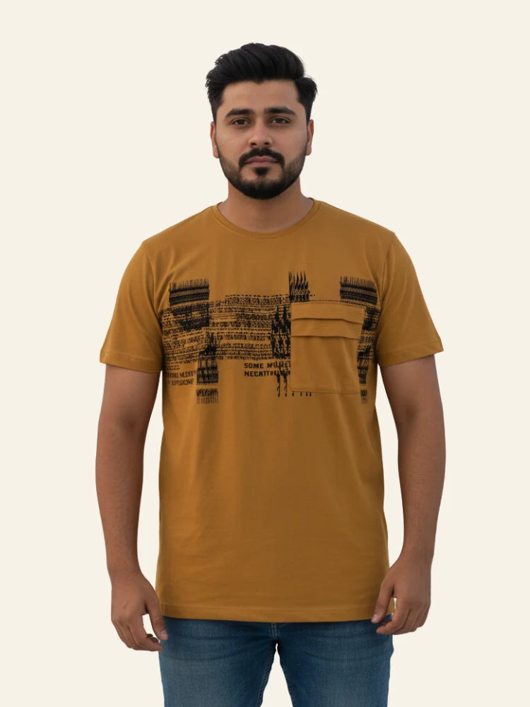 Man wearing a mustard t-shirt with black text design on a beige background