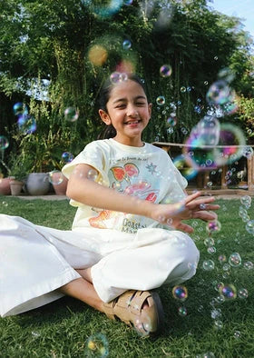 A kid sitting on a grass