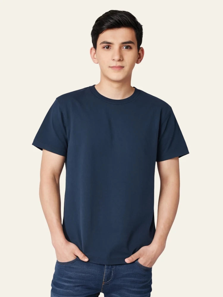 Person wearing a navy blue t-shirt on a plain background Plain Colourful T-Shirt Royal Outfits Plain T-Shirts