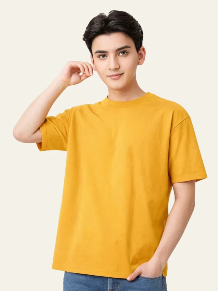Person wearing a yellow t-shirt against a plain background Plain Colourful T-Shirt Royal Outfits Plain T-Shirts