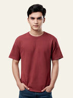 Man wearing a maroon t-shirt against a plain background Plain Colourful T-Shirt Royal Outfits Plain T-Shirts