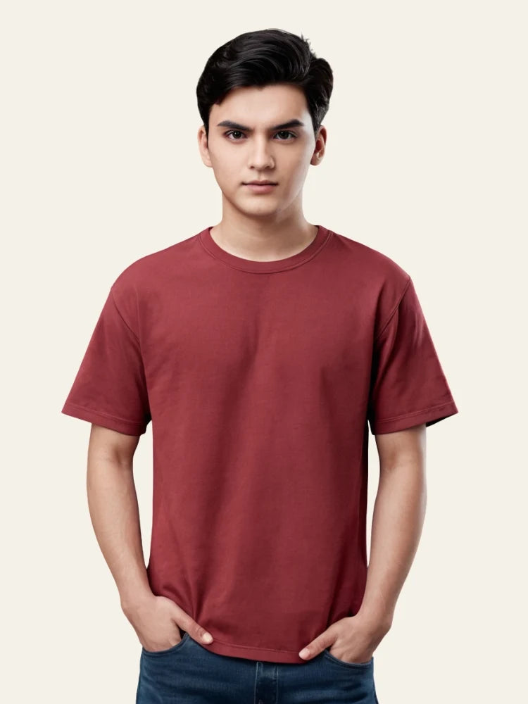 Man wearing a maroon t-shirt against a plain background Plain Colourful T-Shirt Royal Outfits Plain T-Shirts