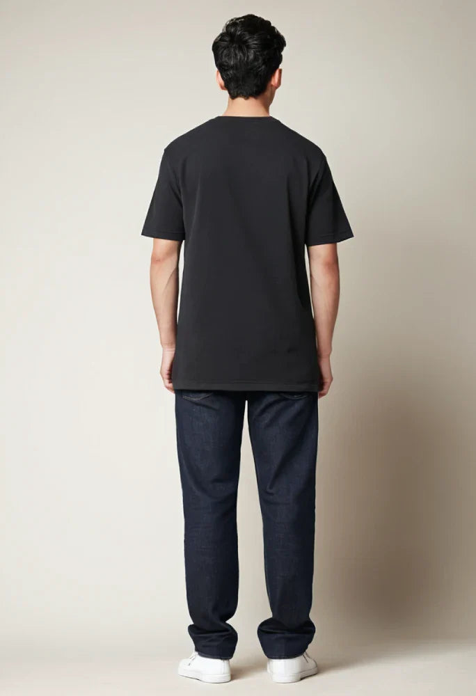 Person wearing a black t-shirt and dark pants against a plain background Graphic Black Boss T-Shirt Royal Outfits Graphic T Shirts