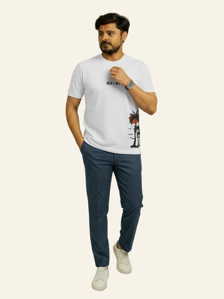 Man wearing a white t-shirt with a graphic design and dark pants on a white background Graphic White Palm T-Shirt Royal Outfits Graphic T Shirts