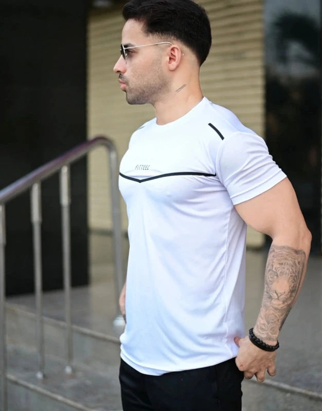 Man wearing a white athletic shirt with a brand logo, standing outdoors. Leisure Icon White & Black Track Suit Royal Outfits Track Suits