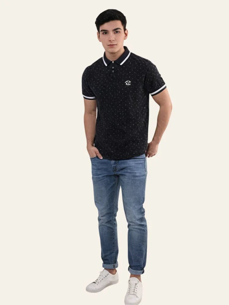 Man wearing a black patterned polo shirt and blue jeans on a white background Black Dotted Regular Fit Men’s Polo T-Shirt Royal Outfits POLO T Shirts - Black Dotted Regular Fit Men’s Polo T-Shirt - Royal Outfits - POLO T Shirts - Black Dotted Regular Fit Men’s Polo T-Shirt - Royal Outfits
