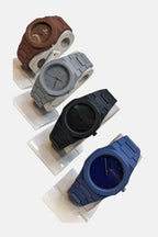 Arabic AURA Four watches in different colours on a white background.