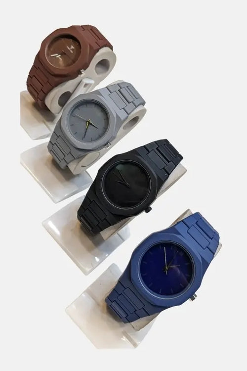 Arabic AURA Four watches in different colours on a white background.