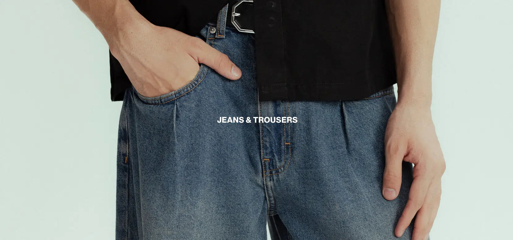 Person wearing blue jeans with a white background and 'JEANS & TRousERS' text.