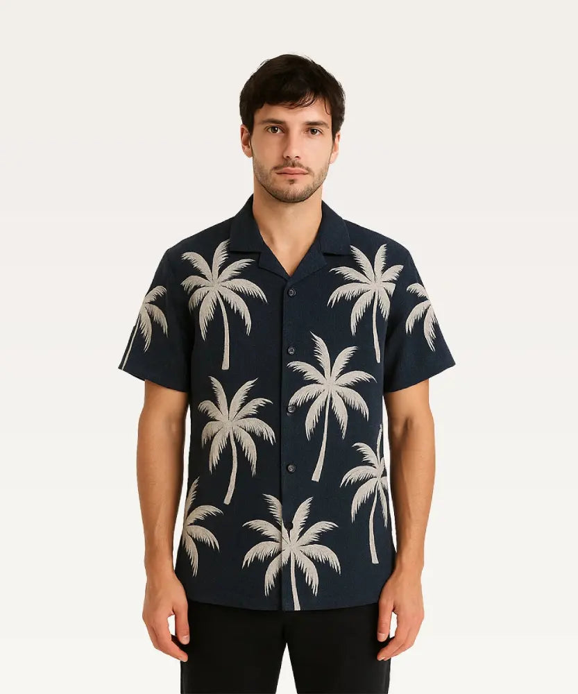 Man wearing a navy blue shirt with palm tree pattern on a white background Black Shirt with Golden Palm Print Royal Outfits Printed Shirts
