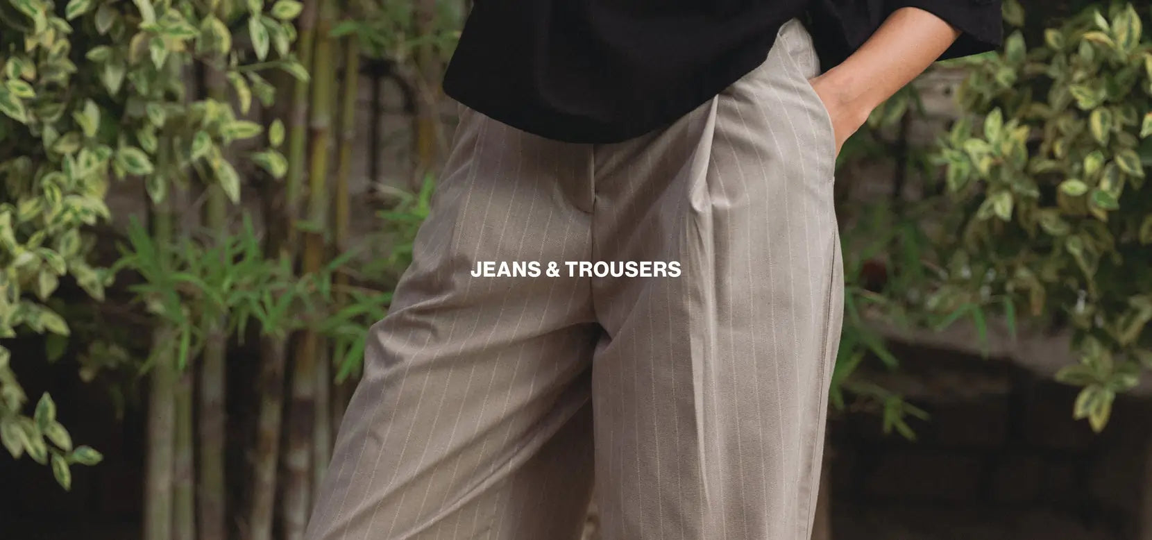 Person wearing beige trousers with a blurred background