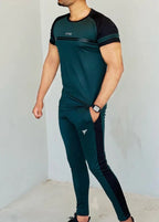 Person wearing a green and black athletic outfit with a visible brand logo on a plain background Pro-Fit Track Suit Royal Outfits Track Suits