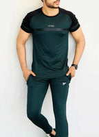 Person wearing a green and black athletic outfit with 'RHYTHM' branding on a white background Pro-Fit Track Suit Royal Outfits Track Suits