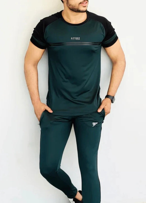 Person wearing a green and black athletic outfit with 'RHYTHM' branding on a white background Pro-Fit Track Suit Royal Outfits Track Suits - Pro-Fit Track Suit - Royal Outfits - Track Suits - Pro-Fit Track Suit - Royal Outfits