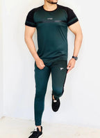 Person wearing a green and black athletic outfit with visible branding on a white background Pro-Fit Track Suit Royal Outfits Track Suits