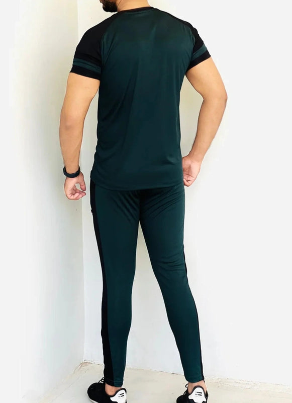 Person wearing a dark green tracksuit against a white wall Pro-Fit Track Suit Royal Outfits Track Suits