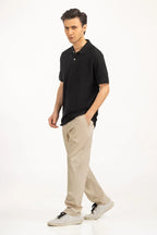 Man wearing a black polo shirt and beige pants on a white background Black Regular Fit Men POLO T-Shirt Royal Outfits POLO T Shirts
