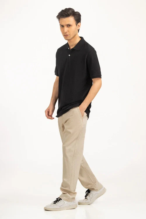 Man wearing a black polo shirt and beige pants on a white background Black Regular Fit Men POLO T-Shirt Royal Outfits POLO T Shirts - Black Regular Fit Men POLO T-Shirt - Royal Outfits - POLO T Shirts