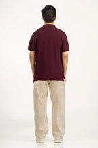 Man wearing a maroon polo shirt and beige pants on a white background Maroon Regular Fit Men POLO T-Shirt Royal Outfits POLO T Shirts