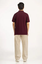 Man wearing a maroon polo shirt and beige pants on a white background Maroon Regular Fit Men POLO T-Shirt Royal Outfits POLO T Shirts - Maroon Regular Fit Men POLO T-Shirt - Royal Outfits - POLO T Shirts - Maroon Regular Fit Men POLO T-Shirt - Royal Outfits