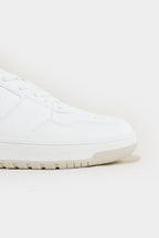 White sneaker on a light beige background Low Top Sneakers Royal Outfits Sneakers