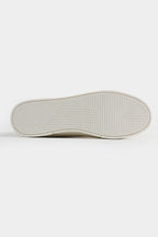Close-up of a white sneaker sole on a light gray background Multi Low Top Sneakers Royal Outfits Sneakers - Multi Low Top Sneakers - Royal Outfits - Sneakers - Multi Low Top Sneakers - Royal Outfits
