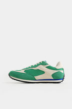 Green and white sneaker on a light gray background