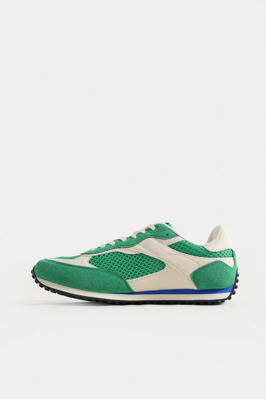 Green and white sneaker on a light gray background