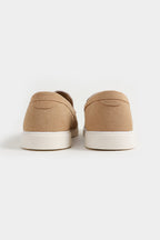 Pair of beige slip-on shoes on a white background Suede Loafers Royal Outfits Loafers