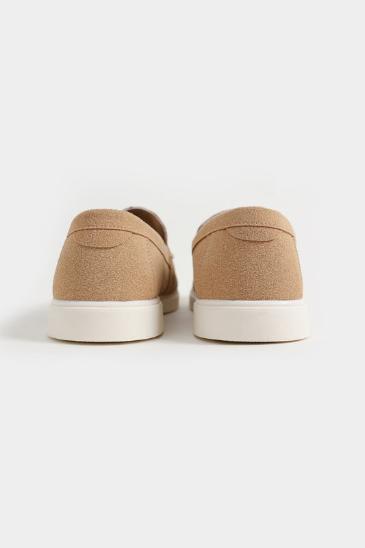 Pair of beige slip-on shoes on a white background Suede Loafers Royal Outfits Loafers