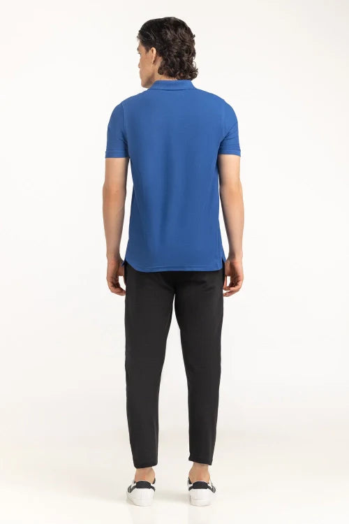 Person wearing a blue polo shirt and black pants on a white background Blue Regular Fit Men POLO T-Shirts Royal Outfits POLO T Shirts
