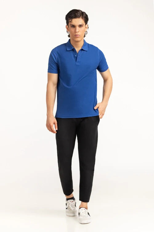 Person wearing a blue polo shirt and black pants on a white background Blue Regular Fit Men POLO T-Shirts Royal Outfits POLO T Shirts
