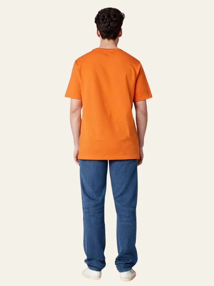 Person wearing an orange t-shirt and blue pants on a white background Graphic Orange Crossword T-Shirt Royal Outfits Graphic T Shirts