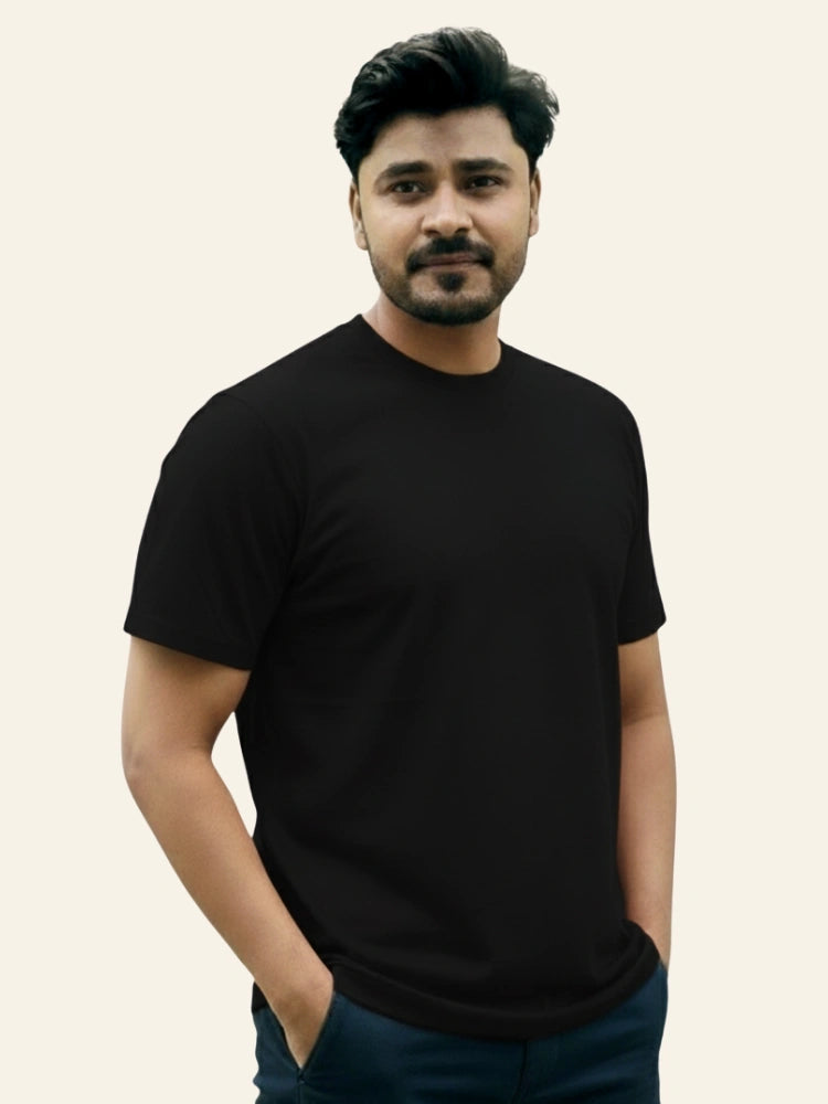 Man wearing a black t-shirt against a plain background Plain Colourful T-Shirt Royal Outfits Plain T-Shirts