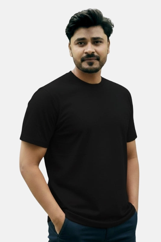 Man wearing a black t-shirt against a plain background Plain Colourful T-Shirt Royal Outfits Plain T-Shirts - Plain Colourful T-Shirt - Royal Outfits - Plain T-Shirts - Plain Colourful T-Shirt - Royal Outfits