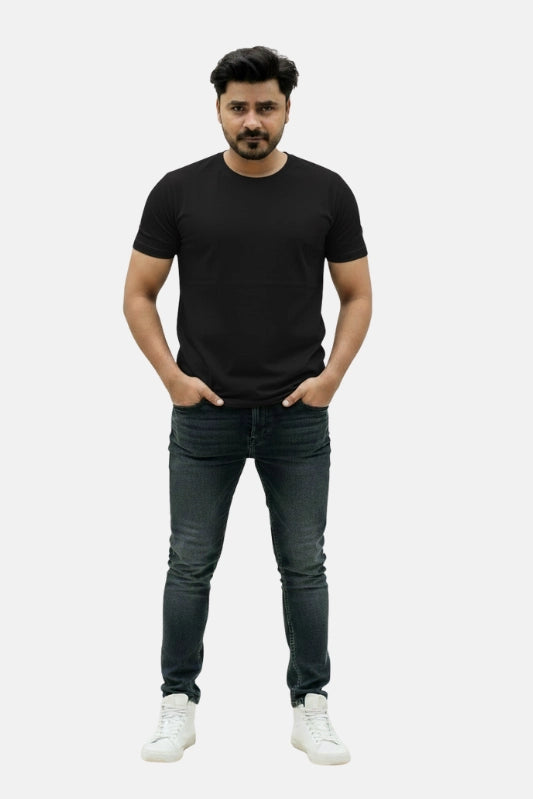 Man wearing a black t-shirt, dark jeans, and white sneakers on a plain background Plain Colourful T-Shirt Royal Outfits Plain T-Shirts - Plain Colourful T-Shirt - Royal Outfits - Plain T-Shirts - Plain Colourful T-Shirt - Royal Outfits