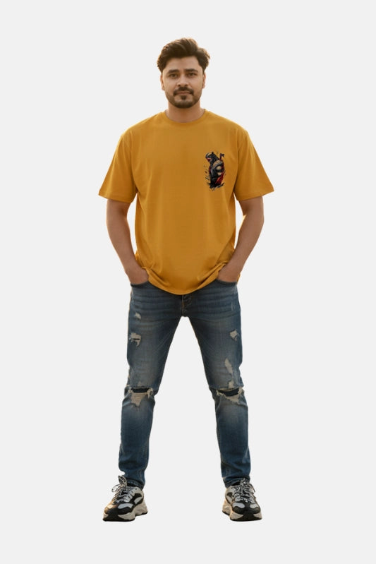 Man wearing a mustard yellow t-shirt with a graphic design and blue jeans on a plain background Graphic Mustard/Yellow Drop Shoulder Axe Man T-Shirt Royal Outfits Drop Shoulder T-Shirts - Graphic Mustard/Yellow Drop Shoulder Axe Man T-Shirt - Royal Outfits - Drop Shoulder T-Shirts