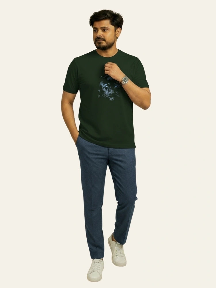 Man wearing a green t-shirt and blue pants on a white background Graphic Dark Green Lion T-Shirt Royal Outfits Printed T Shirts