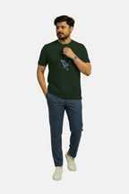 Man wearing a green t-shirt and blue pants on a white background Graphic Dark Green Lion T-Shirt Royal Outfits Printed T Shirts - Graphic Dark Green Lion T-Shirt - Royal Outfits - Printed T Shirts