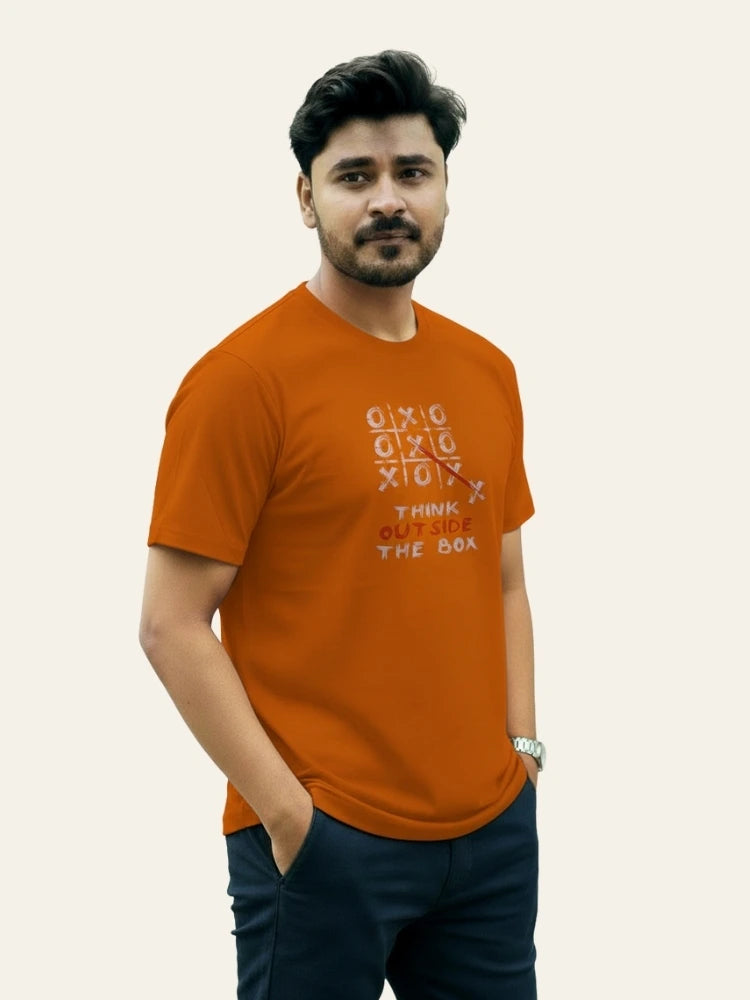 Man wearing an orange t-shirt with text on a plain background Graphic Orange Crossword T-Shirt Royal Outfits Graphic T Shirts