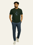 Man wearing a green t-shirt with a graphic design and blue pants on a white background Graphic Dark Green Lion T-Shirt Royal Outfits Printed T Shirts
