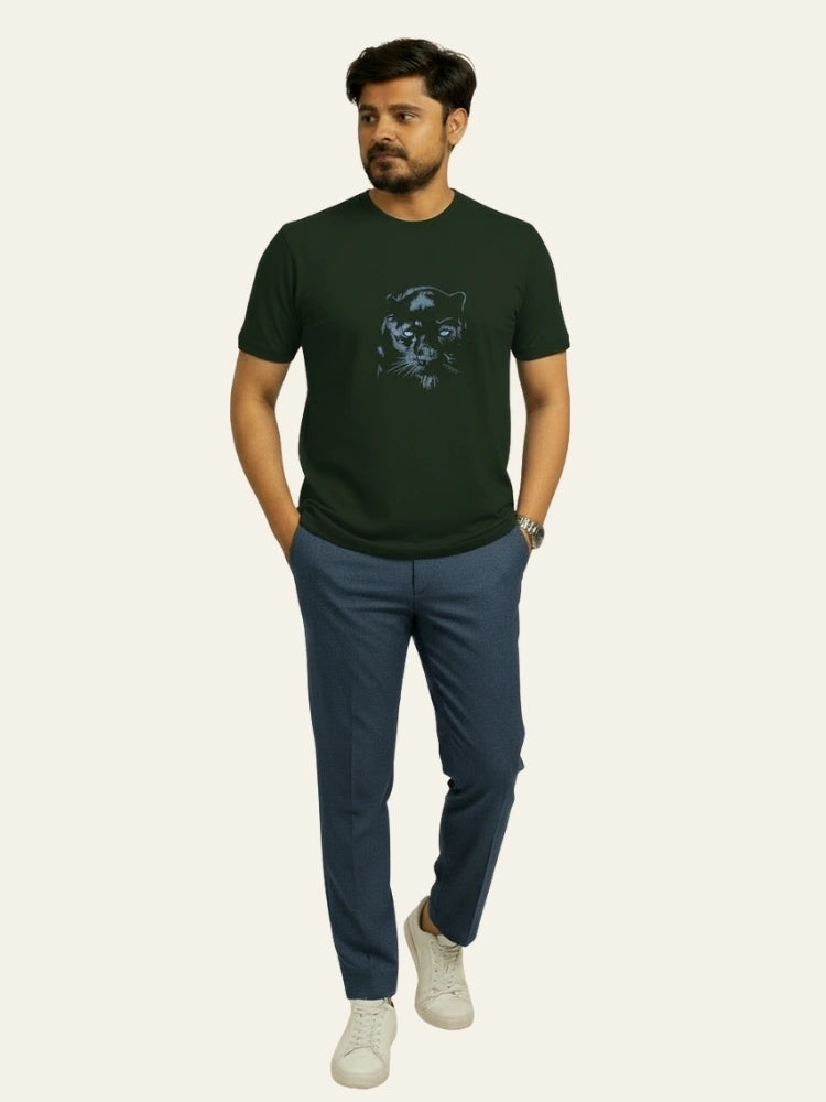 Man wearing a green t-shirt with a graphic design and blue pants on a white background Graphic Dark Green Lion T-Shirt Royal Outfits Printed T Shirts