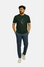 Man wearing a green t-shirt with a graphic design and blue pants on a white background Graphic Dark Green Lion T-Shirt Royal Outfits Printed T Shirts - Graphic Dark Green Lion T-Shirt - Royal Outfits - Printed T Shirts - Graphic Dark Green Lion T-Shirt - Royal Outfits