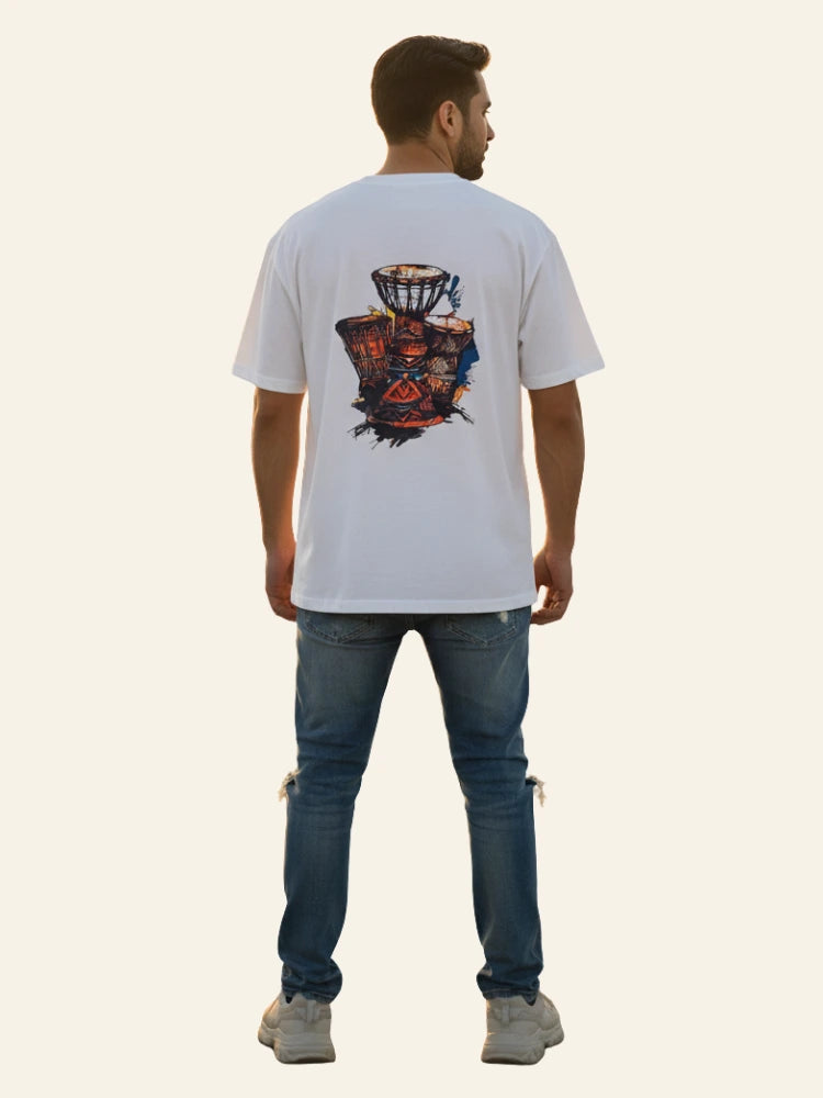 Man wearing a white t-shirt with a colorful design on the back, standing against a plain background. Graphic White Drop Shoulder "Dhool" T-Shirt Royal Outfits Drop Shoulder T-Shirts